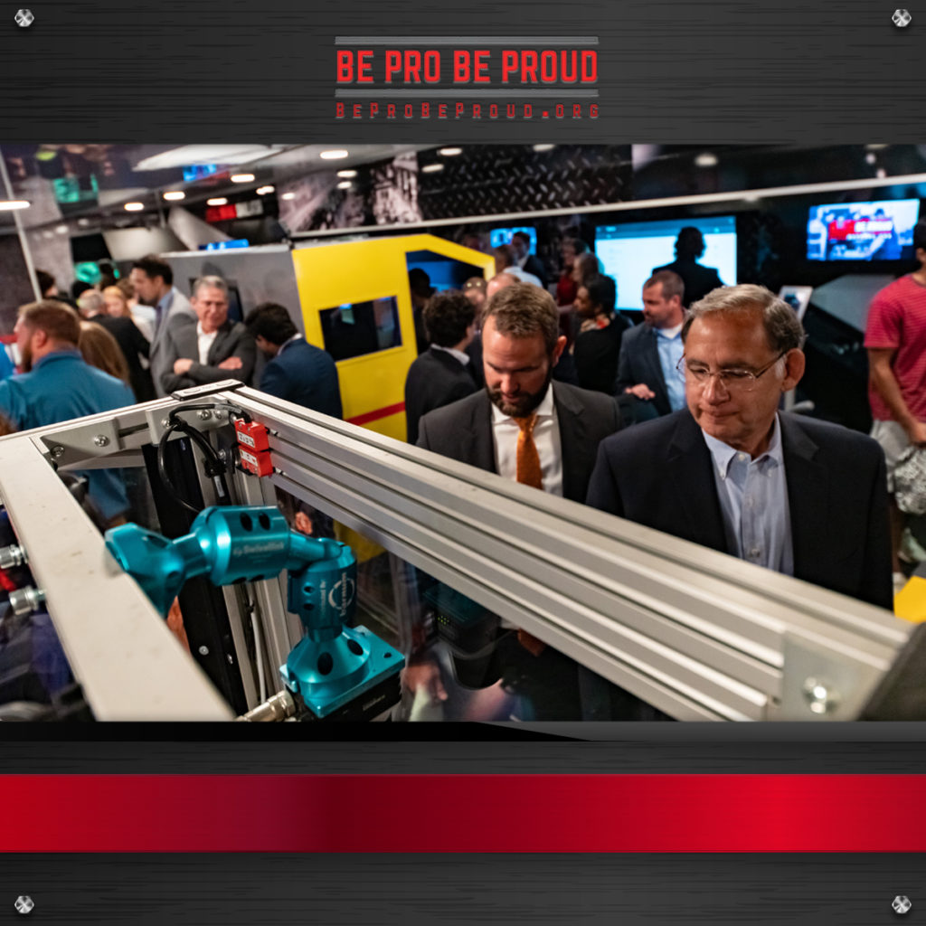 Men looking at tools and demos at the Be Pro Be Proud experiential marketing event and truck unveiling 